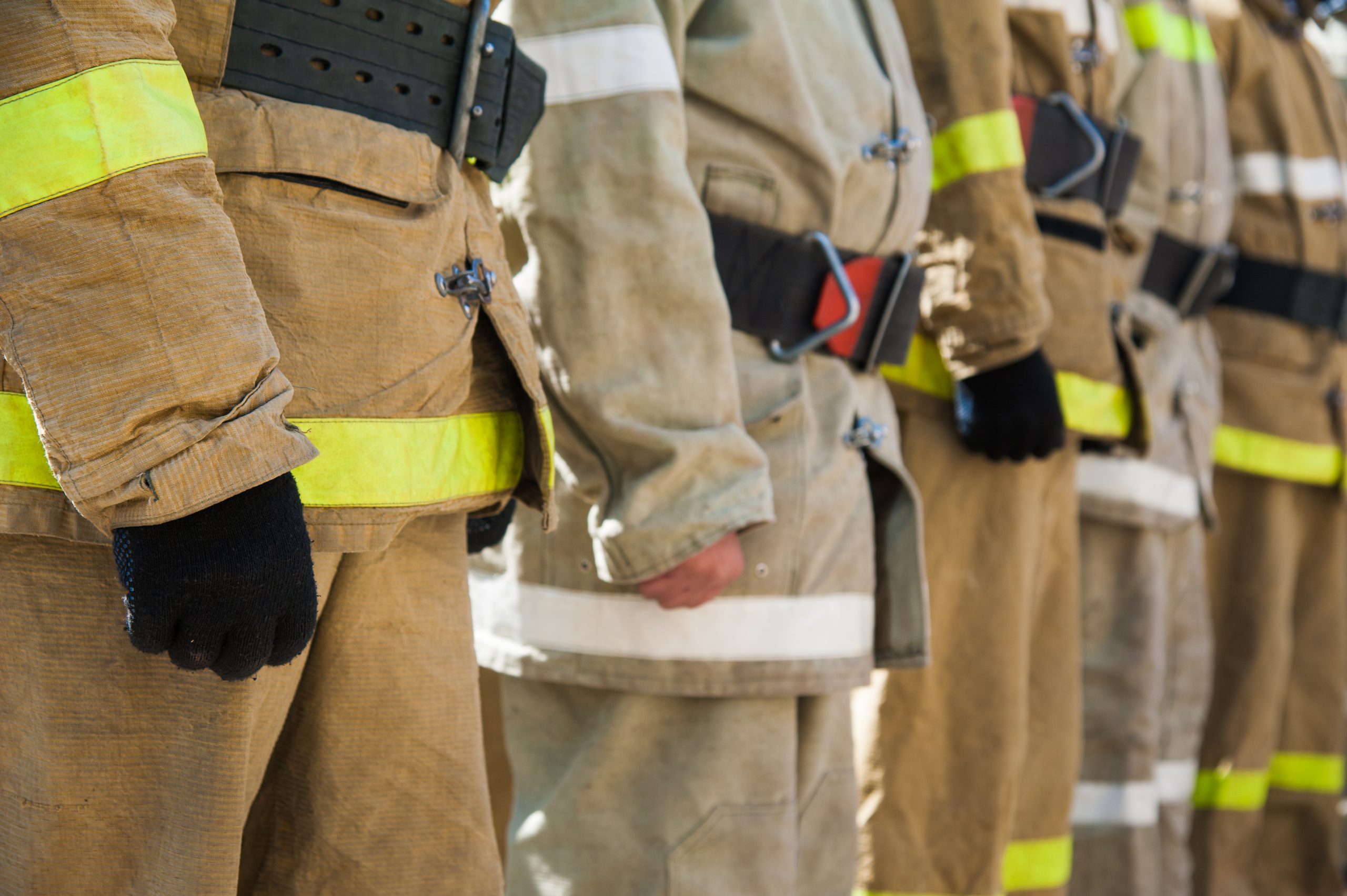 firefighters-standing-in-a-row-wearing-protective-gear