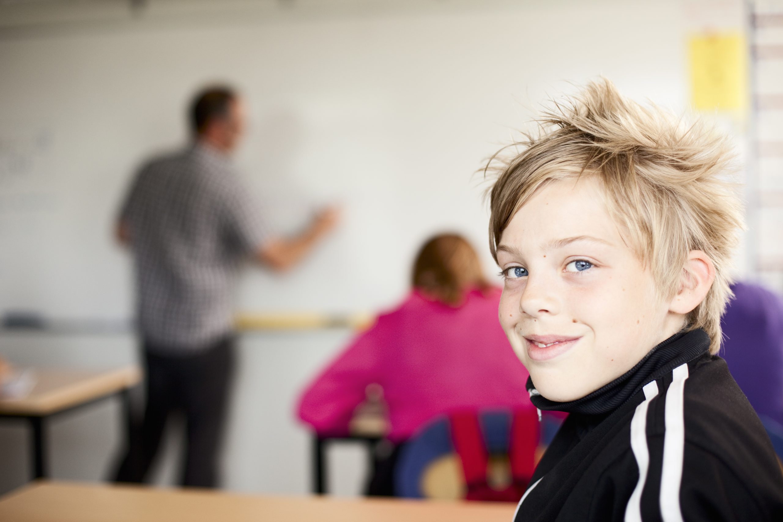 Portrait of boy sitting in classroom